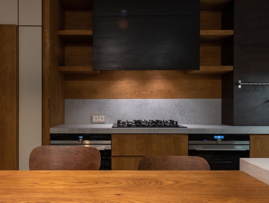 Elegant modern kitchen design featuring wooden elements and sleek appliances.