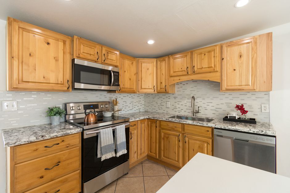 Spacious kitchen with wood cabinets, granite countertops, and stainless steel appliances.