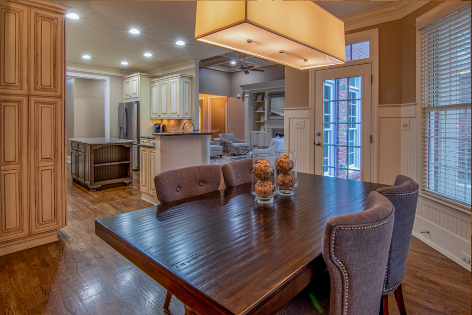 Kitchen with wooden cabinets and a table with chairs.
